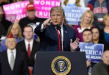 Crime Drop Fuels Trump Showdown politician speaking at a rally podium