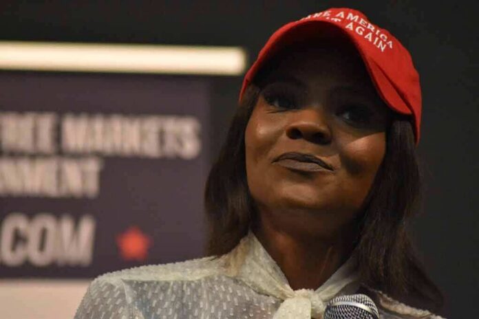 woman in a red cap holding a microphone