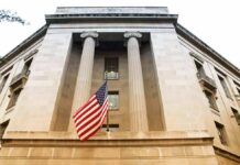 USDA Nepotism Scheme Exposed American flag hanging on a neoclassical government building