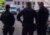 ICE’s Bold Pick Sparks Furious Debate Police officers stand on a city street
