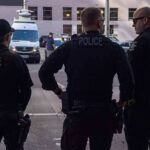 ICE’s Bold Pick Sparks Furious Debate Police officers stand on a city street