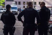 ICE’s Bold Pick Sparks Furious Debate Police officers stand on a city street
