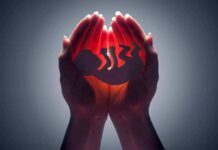 Stigma Surge Muzzles Abortion Debate Hands cupping a glowing fetal silhouette
