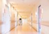 Pharma Cash Drains Small-Town Hospitals Hospital corridor with doors and medical cart