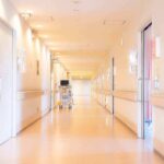 Pharma Cash Drains Small-Town Hospitals Hospital corridor with doors and medical cart