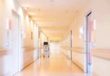 Pharma Cash Drains Small-Town Hospitals Hospital corridor with doors and medical cart