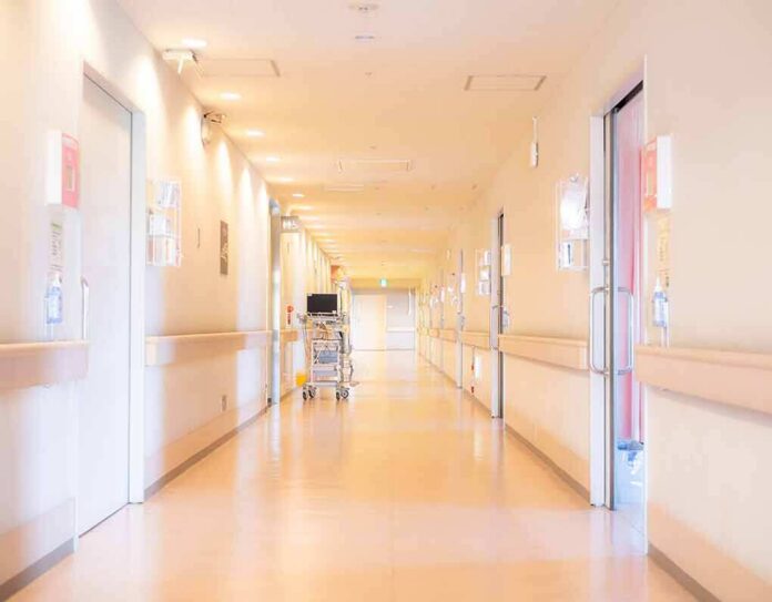 shutterstock_1415542664 Hospital corridor with doors and medical cart