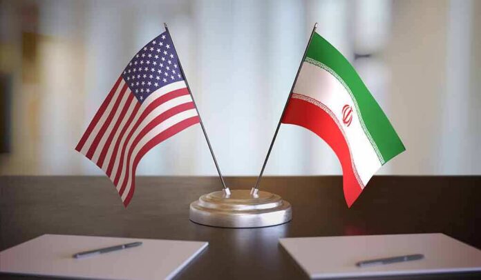 shutterstock_1609200817 United States and Iran desk flags on a stand