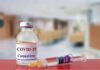 Hiding Numbers? CDC’s COVID Debate Leaks vaccine vial and syringe on a counter in a clinic