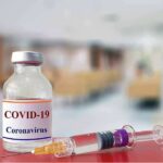 Hiding Numbers? CDC’s COVID Debate Leaks vaccine vial and syringe on a counter in a clinic