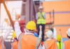 Border Brawl Hits Michigan Paychecks construction workers raising fists during a safety briefing
