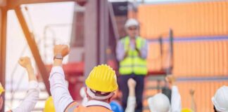 construction workers raising fists during a safety briefing