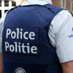 Anonymous Tip Stops Preschool Carnage Plan Police officer in uniform seen from the back