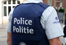 Anonymous Tip Stops Preschool Carnage Plan Police officer in uniform seen from the back