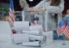 Election Loophole Sparks Minnesota Firestorm Person casting a ballot into a clear box at a polling station