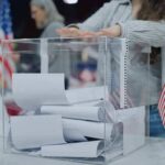Election Loophole Sparks Minnesota Firestorm Person casting a ballot into a clear box at a polling station