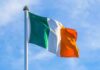 Record Hate Crimes Rattle Northern Ireland Irish flag on a flagpole against a blue sky