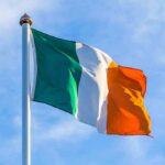 Record Hate Crimes Rattle Northern Ireland Irish flag on a flagpole against a blue sky