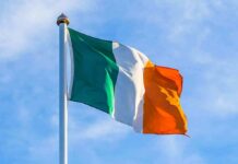 Record Hate Crimes Rattle Northern Ireland Irish flag on a flagpole against a blue sky