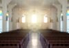 Shanghai Crackdown Reaches Church Aisles Empty church interior with sunlight at the altar