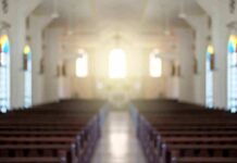 Shanghai Crackdown Reaches Church Aisles Empty church interior with sunlight at the altar
