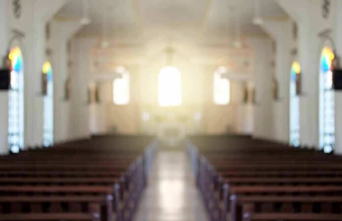 shutterstock_588868961 Empty church interior with sunlight at the altar