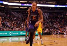 Olympic Icon Torches WNBA’s ‘Woman’ Gap basketball player dribbling on a court during a game