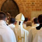 Church Civil War Erupts Over Divorce Bishop in white mitre among clergy during church procession