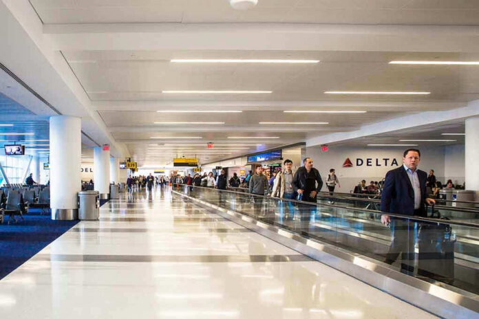 1089085346 Airport terminal with passengers on a moving walkway