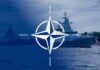 Russia’s Gray-Zone Gambit Rattles NATO NATO emblem overlaying naval ships in the ocean.