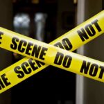Bail Blowback Erupts After Parade Shooting Yellow crime scene tape crossing a doorway