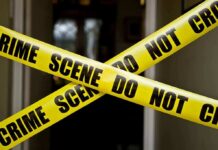 Bail Blowback Erupts After Parade Shooting Yellow crime scene tape crossing a doorway