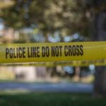 Record Drop Stuns Chicago Summer yellow police tape cordoning off an outdoor area