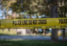 Record Drop Stuns Chicago Summer yellow police tape cordoning off an outdoor area