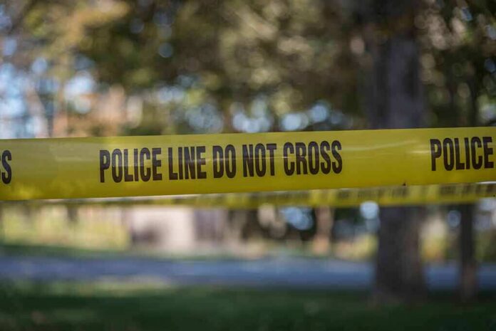 yellow police tape cordoning off an outdoor area