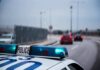 Arrows Rain On Busy UK Road Police car with blue lights on near a roadway