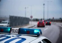 Arrows Rain On Busy UK Road Police car with blue lights on near a roadway