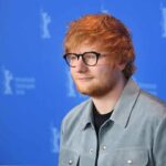 Gaza Flashpoint Engulfs Ed’s Tour Ed Sheeran posing at a photo call against a blue backdrop