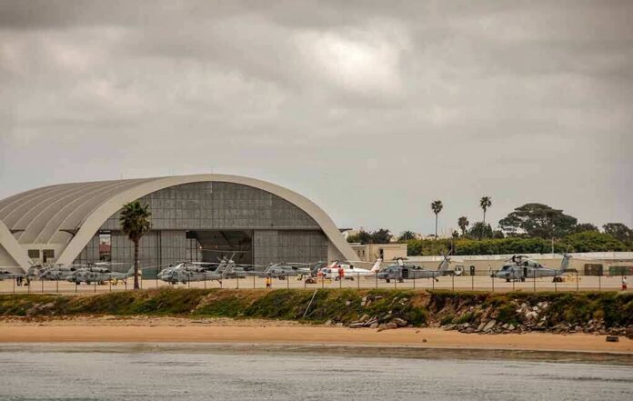 airport hangar with helicopters near a shoreline