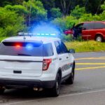 Police Pursuit Slams Bus — Driver Runs Police SUV with flashing lights at roadside crash scene