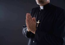 Cardinal’s Call Sparks Fury in Chicago Clergyman in black robe praying with hands together