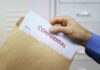 Declassified Shock: Hijack Plot Flagged Early Hand placing confidential document into a brown envelope