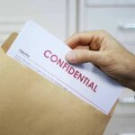 Declassified Shock: Hijack Plot Flagged Early Hand placing confidential document into a brown envelope