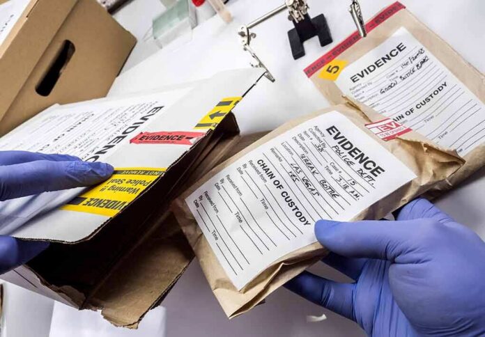 shutterstock_1400793416 Gloved hands handling labeled evidence bags and boxes