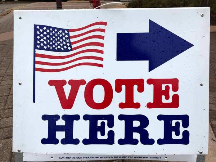 shutterstock_1402772576 voting sign with arrow and American flag