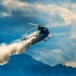 Fatal Double Tragedy Grips LA Airspace Helicopter releasing smoke over mountains
