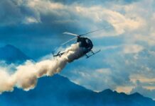 Fatal Double Tragedy Grips LA Airspace Helicopter releasing smoke over mountains