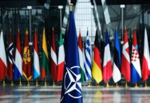 NATO Slaps Down Moscow’s Hybrid Gambit NATO flag with member country flags in the background