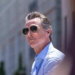 FBI File Haunts California Mega-Donors Gavin Newsom wearing sunglasses outdoors