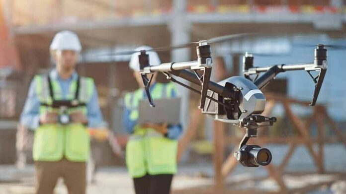 shutterstock_1712804086 drone with camera flying at construction site